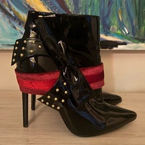 Black shoes with red and gold accents.